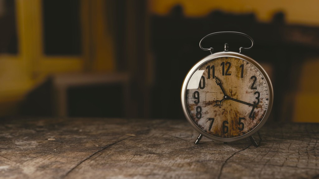 selective focus photography gray analog clock on black surface