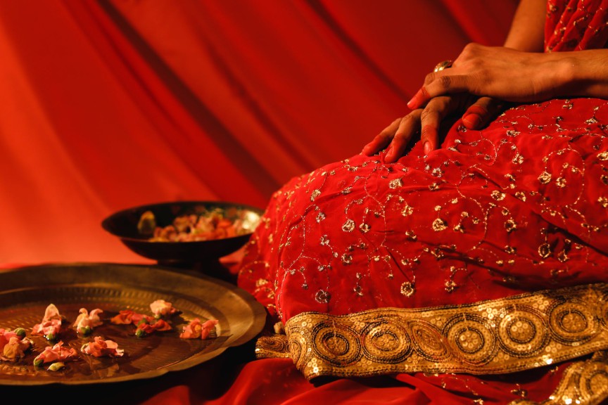 a person kneeling beside the metal plate