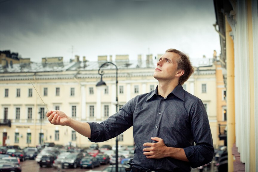 Conductor Vasily Petrenko outside with baton