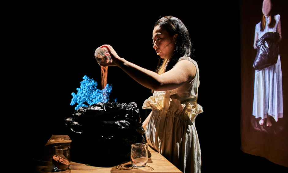 Women pouring soil from a glass