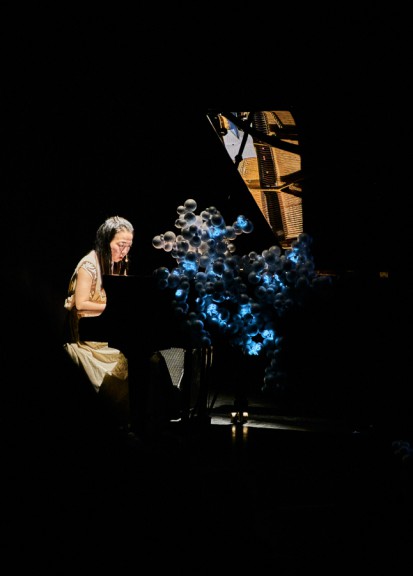 Woman playing piano on stage