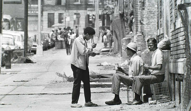 Men chatting on a sidewalk