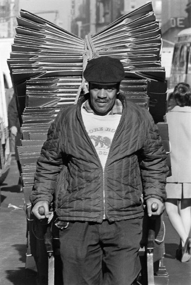 Black man pulling handcart