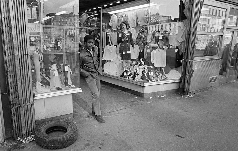 Black man standing in front of clothing store