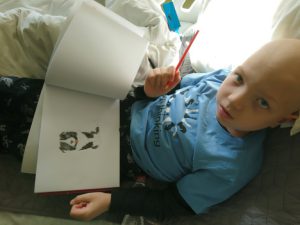 Boy drawing in hospital bed