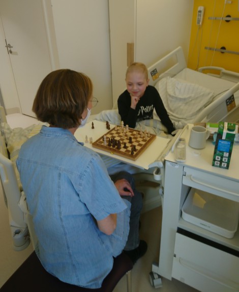 Boy playing chess in hospital