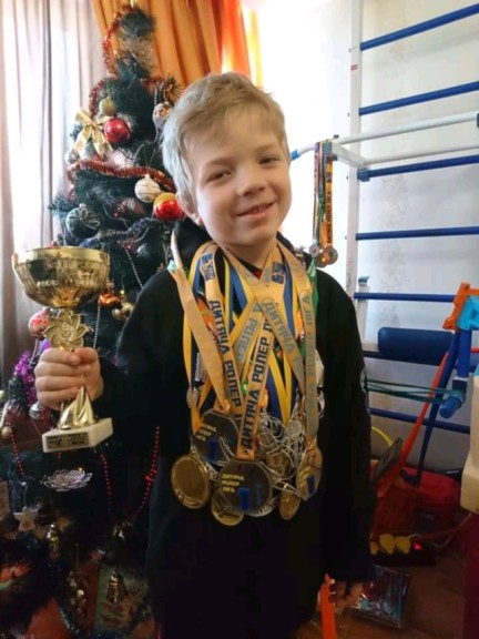 Boy with medals and trophies