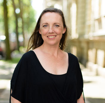 Woman dressed in black smiling