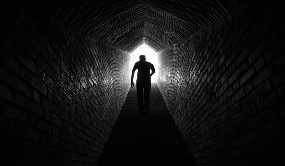 Man emerging from tunnel