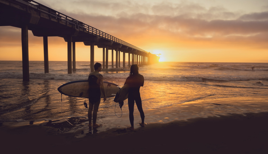 surfers at sunset