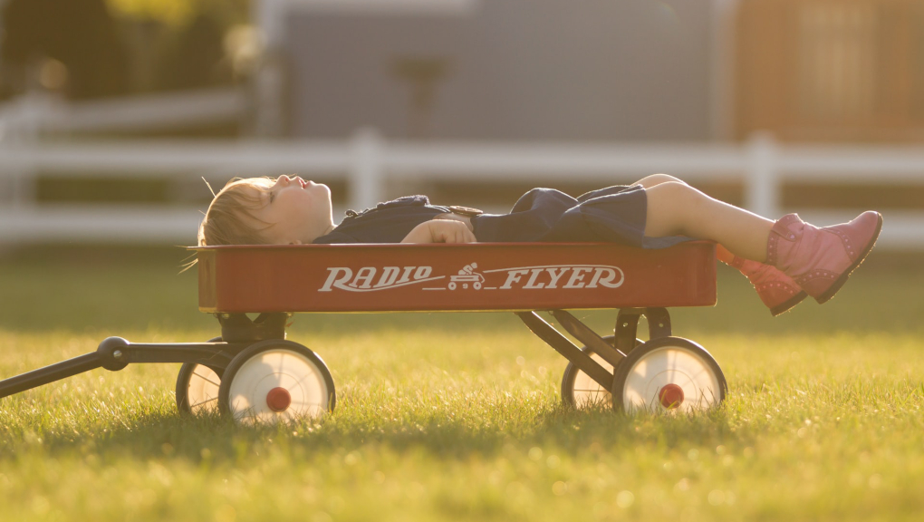 child lying in cart