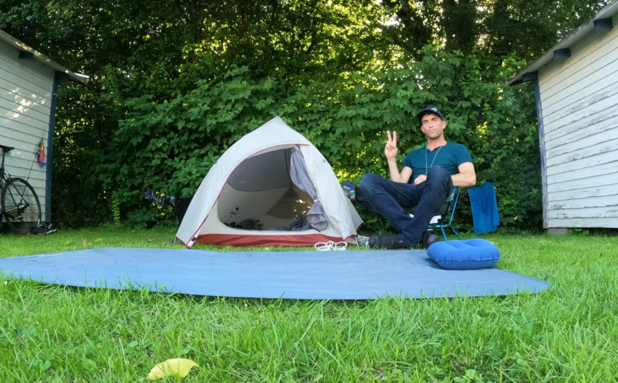 Man sitting next to tent