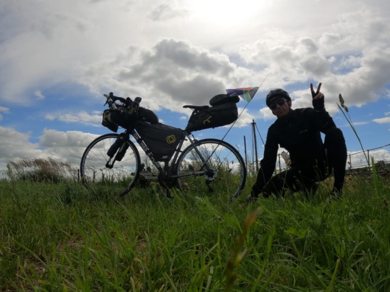 Man with bike in green field