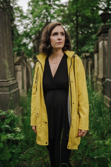 Woman wearing yellow jacket in cemetery