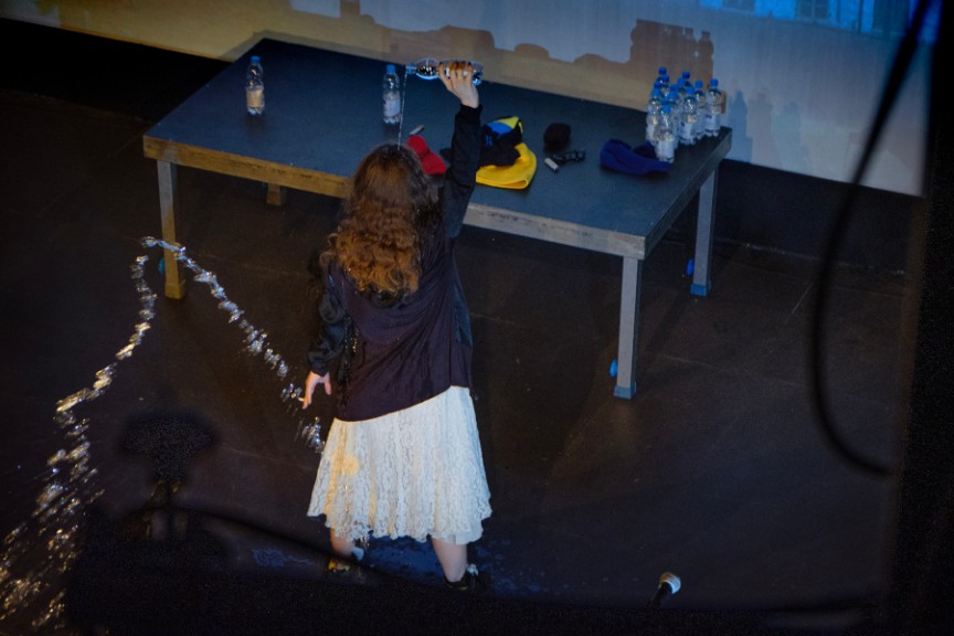 Female performer pouring water over herself