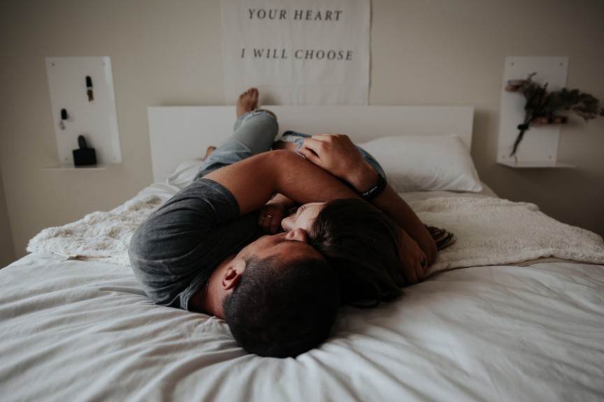 Couple embracing on bed