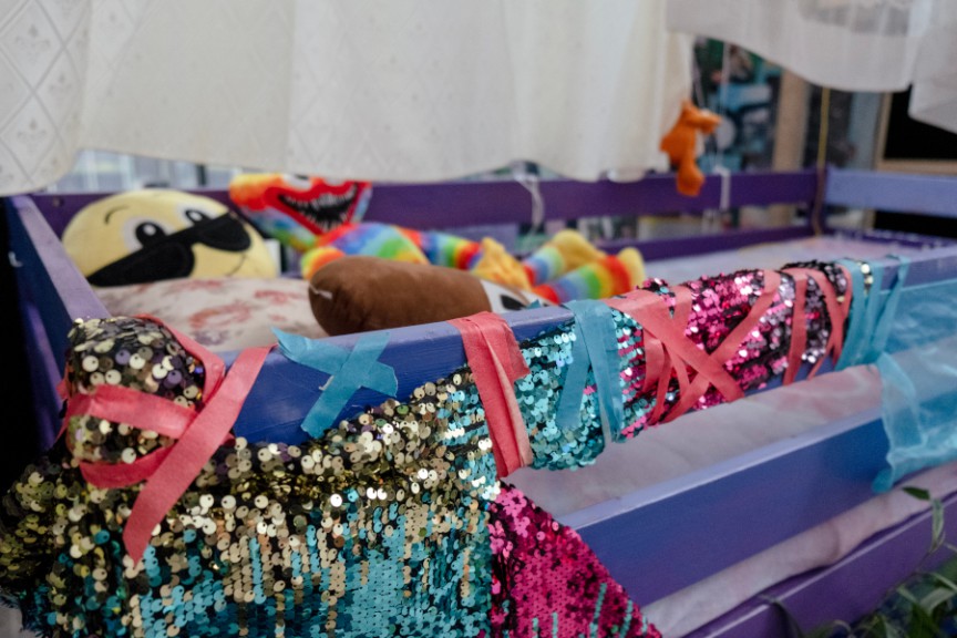 various pieces of sequined ribbon and fabric on painted bed