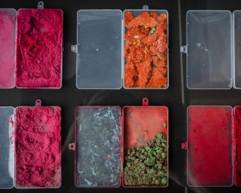Brightly coloured paint in plastic containers