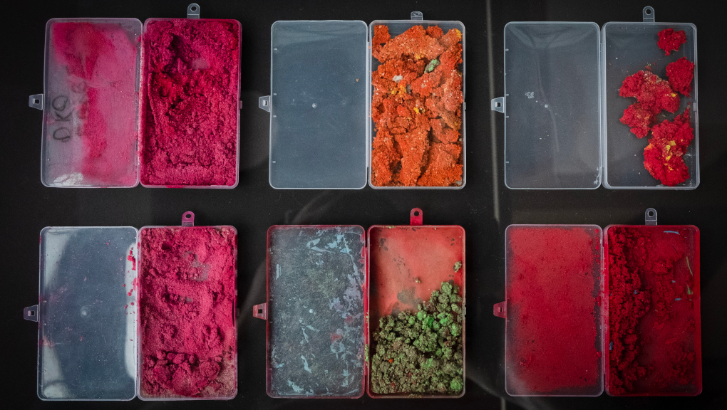 Brightly coloured paint in plastic containers