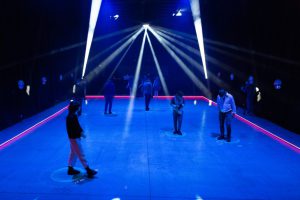 people standing on blue floor surface light by spotlights