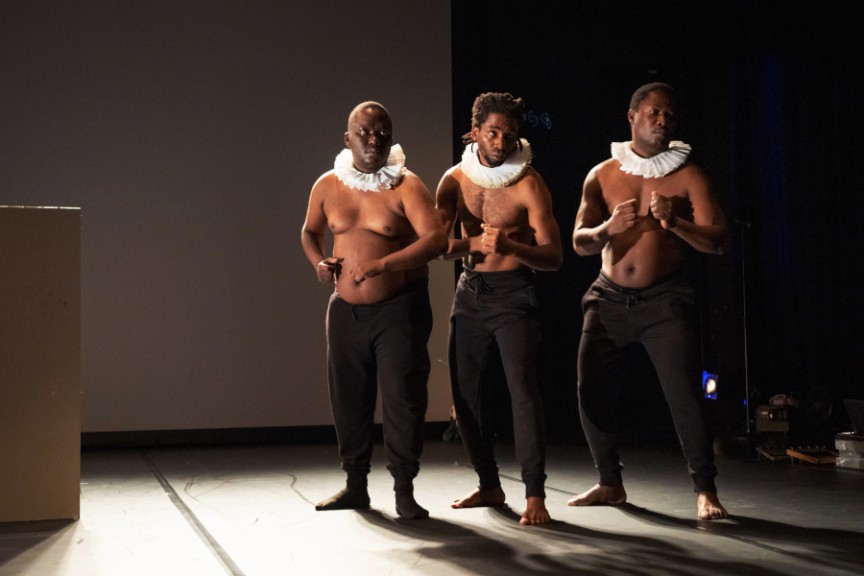 Three African men in costume on stage