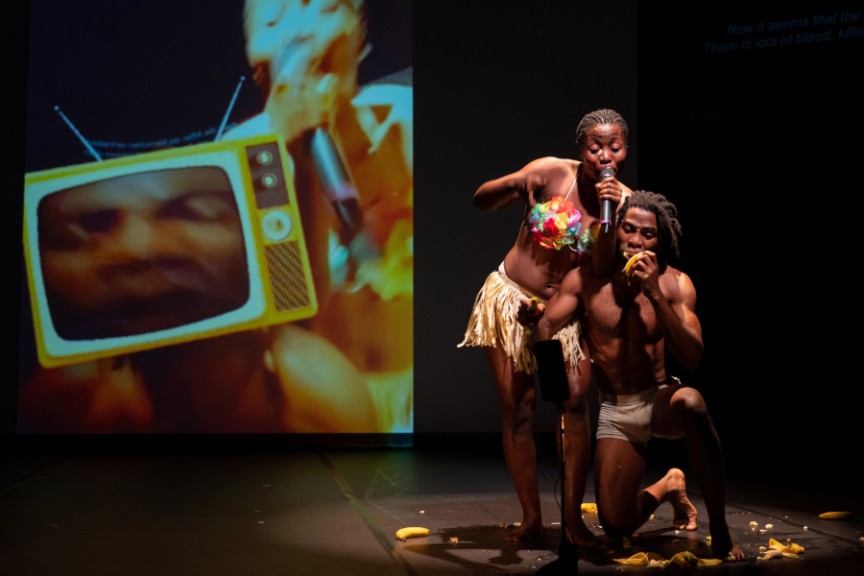 Two actors in African traditional dress on stage