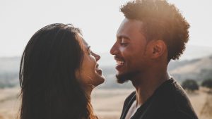 close up of man and woman facing each other smiling