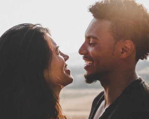 close up of man and woman facing each other smiling