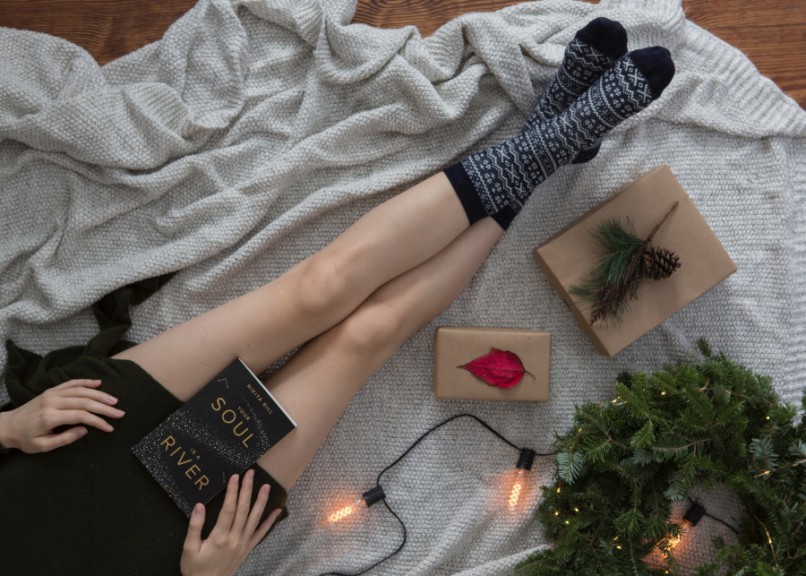 woman's legs in socks from elevated view next to gifts