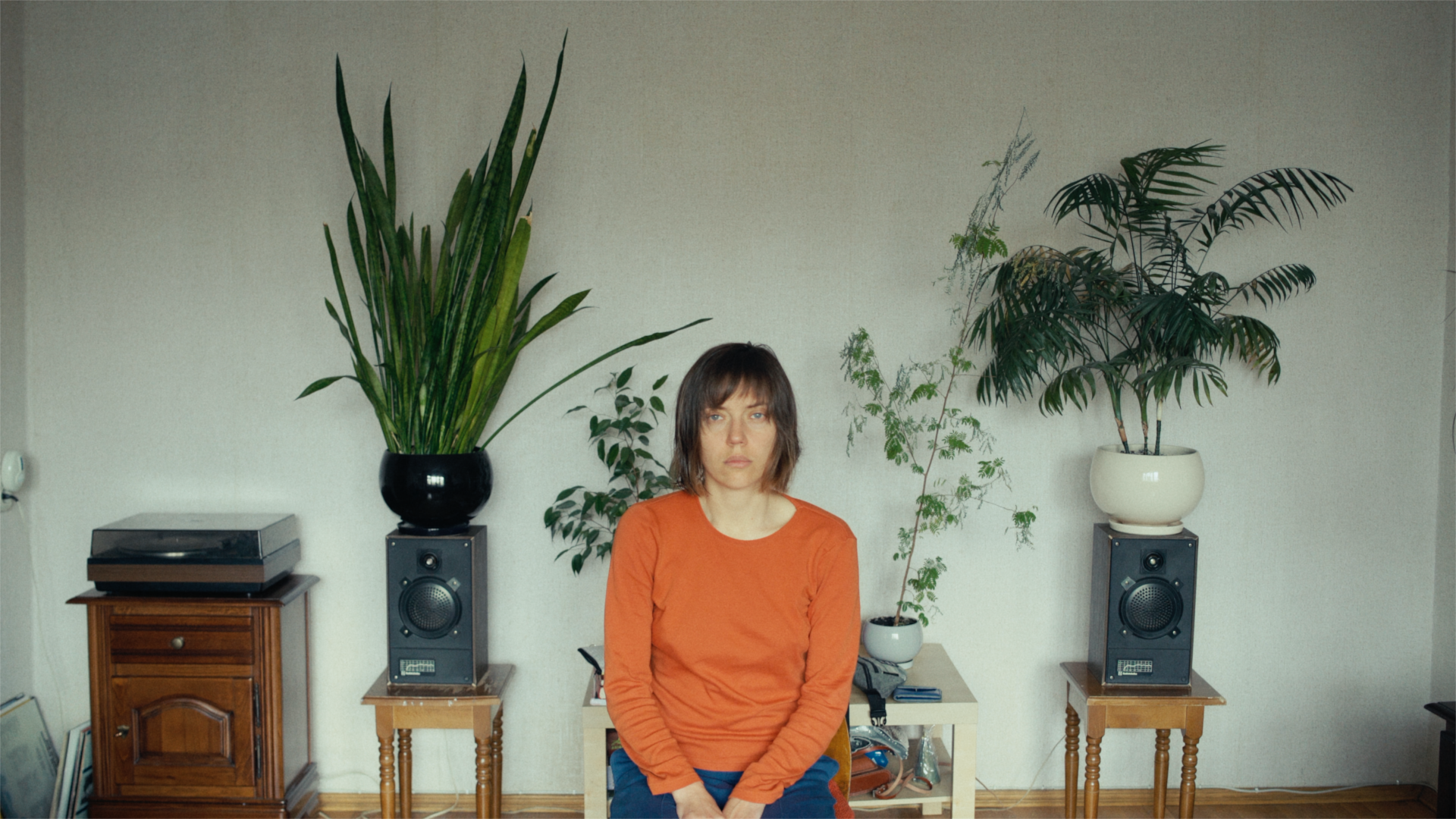 nadia parfan sits in front of her houseplants